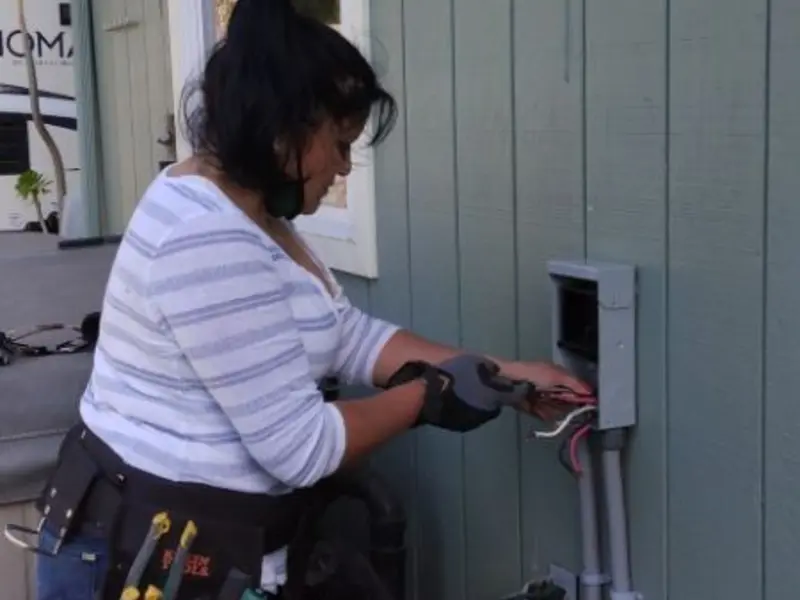 Licensed electrician wiring an exterior subpanel in Le Sueur